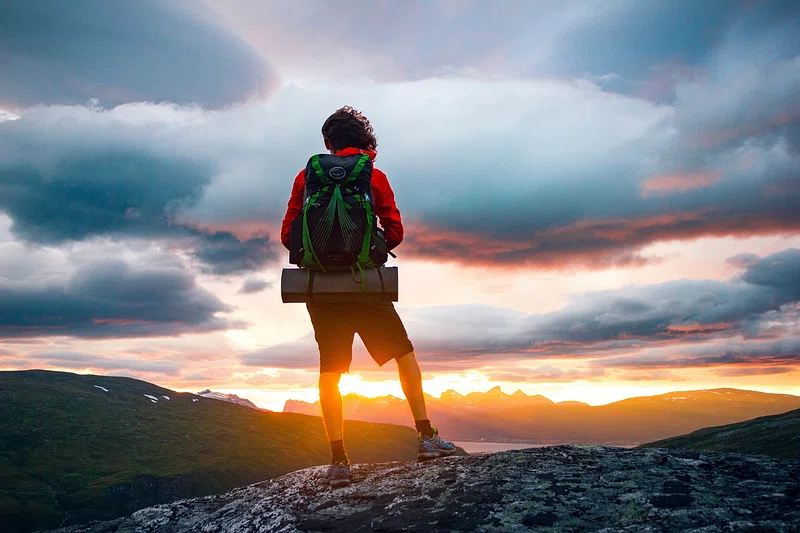 a person standing on a rock looking at the sunset Epic Himalayan Treks: 