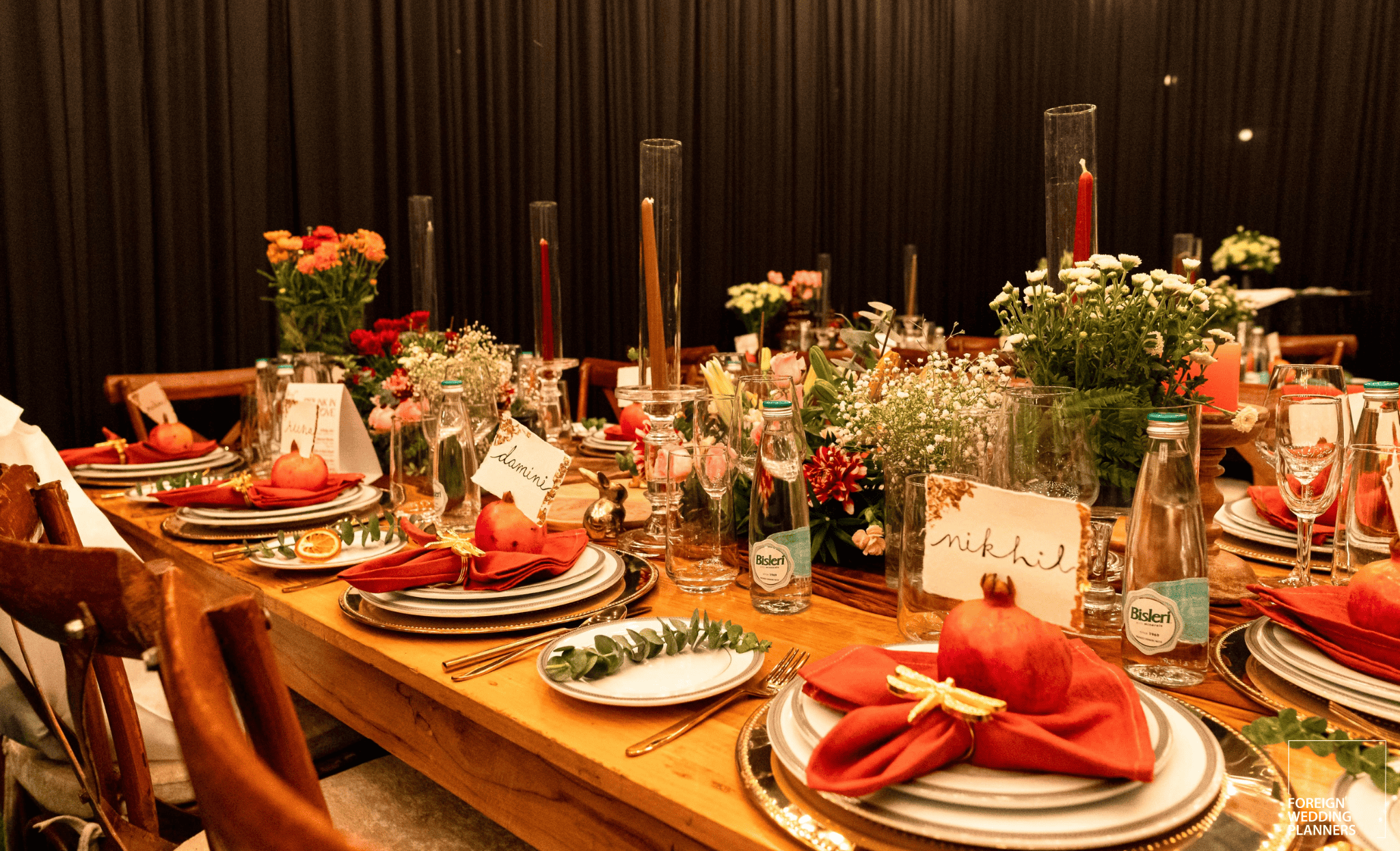 a table with plates and glasses and flowers
Indian Wedding Guide 2025: Experiential dining is gaining popularity. Image courtesy: Foreign Wedding Planners
