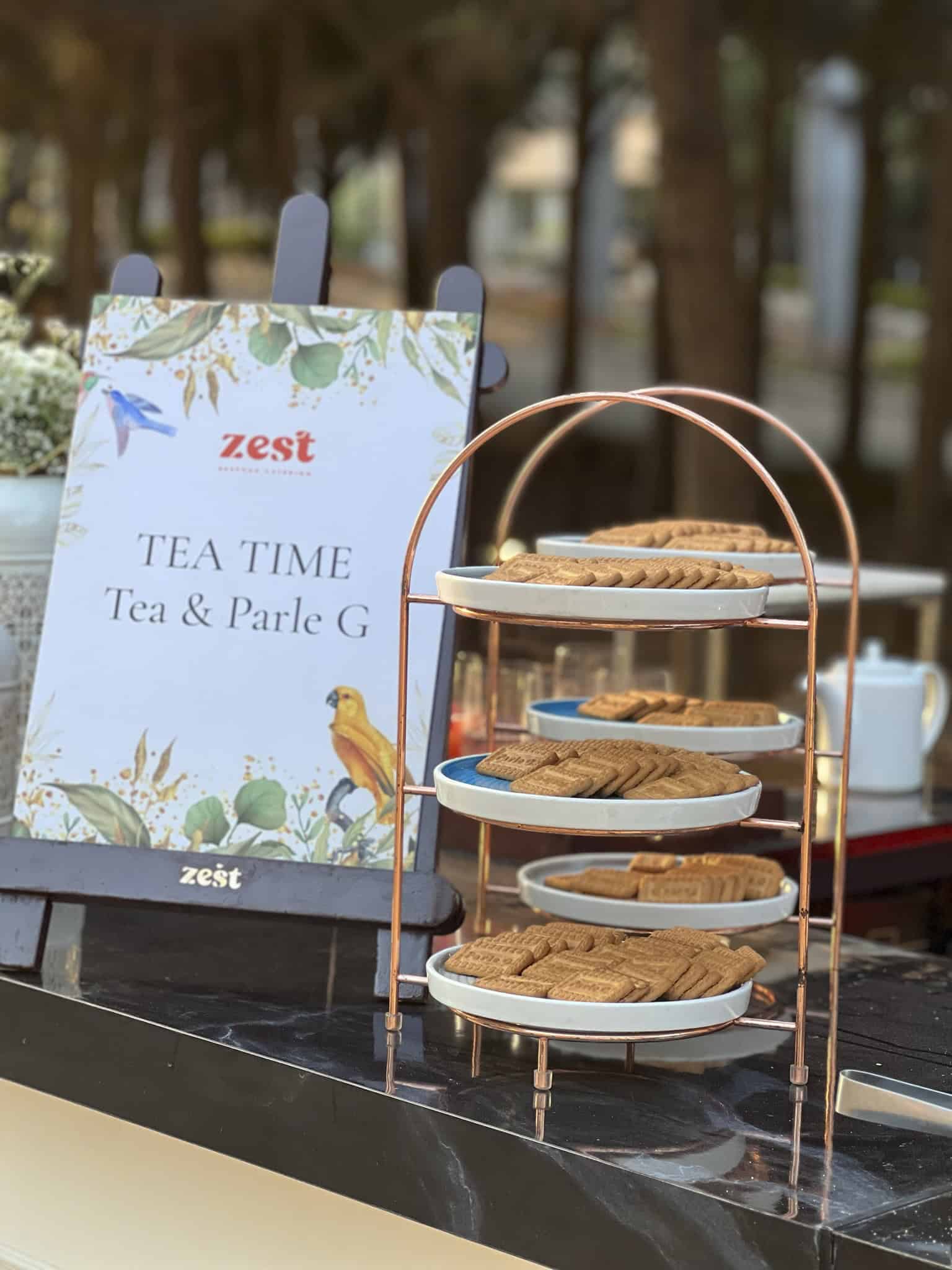 Nostalgic comfort foods like Parle-G biscuits savored during tea time. Image courtesy: Divya Vithika Wedding Planners