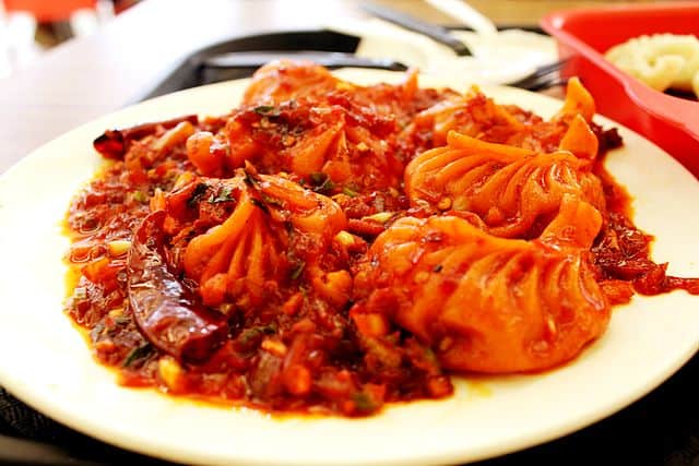 Soft, steamed, and soul-warming, Gangtok’s momos are a mountain hug in every bite, served hot with a side of fiery red chutney that packs a punch. Courtesy: Wikimedia