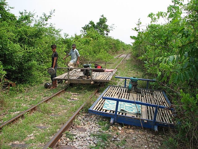 Zooming across rice fields on a bamboo platform powered by a motorbike engine, the Battambang Bamboo Train offers a thrilling, back-to-basics ride through Cambodia’s countryside, an unforgettable journey of speed, simplicity, and stunning tropical landscapes. Courtesy: Gonzo Gooner, Wikimedia