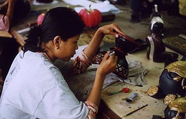 A woman is working with a lacquered vase. Courtesy: Marc A. Garrett, Wikimedia.
