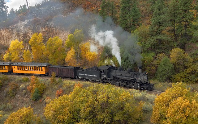 The Durango & Silverton Narrow Gauge Railroad winds through Colorado’s wild canyons and pine forests, offering a thrilling heritage ride aboard vintage steam trains, complete with mountain vistas, waterfalls, and the untamed beauty of the American West. Courtesy: John Fowler, Wikimedia