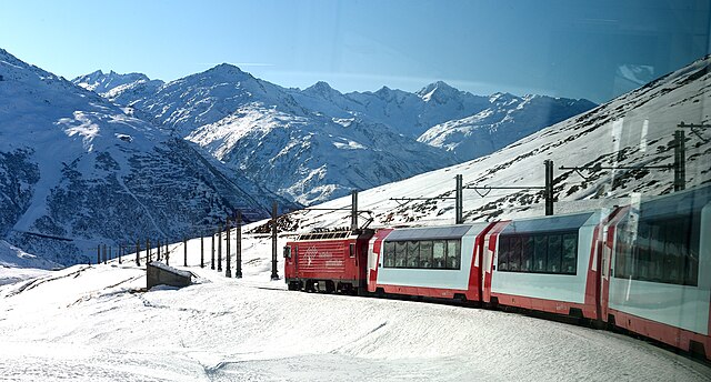 Gliding through the heart of the Swiss Alps, the Glacier Express offers a luxurious slow ride past alpine meadows, snowy peaks, and charming villages—crossing 291 bridges and 91 tunnels on one of the world’s most scenic train journeys. Courtesy: Tim Adams, Wikimedia.