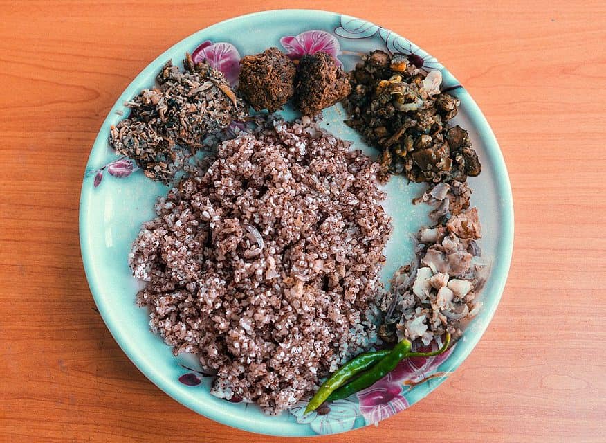 Jadoh is a beloved Khasi dish from Meghalaya, made with rice and pork, slow-cooked with local spices—flavourful, earthy, and a highlight of tribal feasts and celebrations. Courtesy: Wikimedia