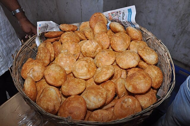 Golden, flaky, and packed with bold masala, Jaipur’s iconic kachori is more than a snack—it’s a royal bite of Rajasthan’s culinary heritage served hot on every vibrant street corner. Courtesy: Wikimedia